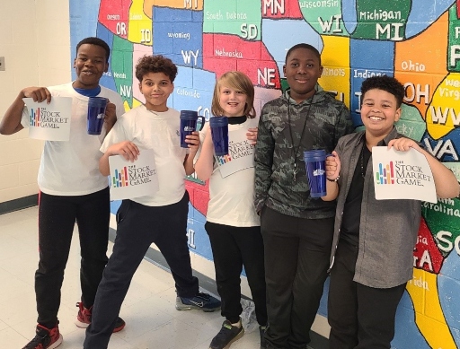  Leasure students holding signs that read The Stock Market Game